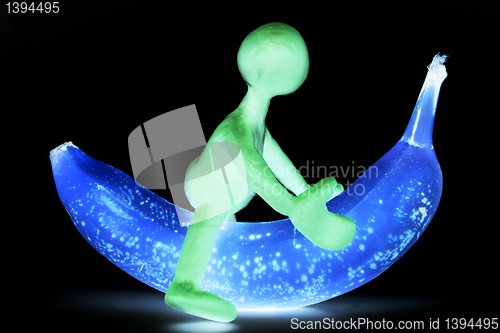 Image of Shaded puppet of plasticine riding on banana