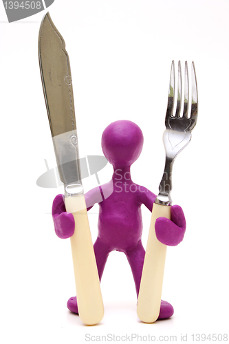 Image of Purple puppet  standing with tableware