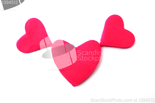 Image of Painted pink hearts of plasticine on background
