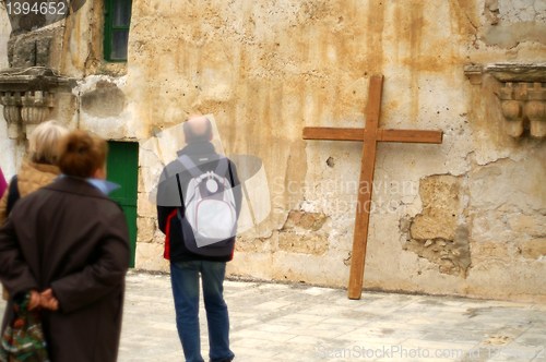 Image of pilgrim with a cross in  jerusalem