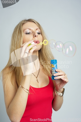 Image of Pretty girl with soap bubbles