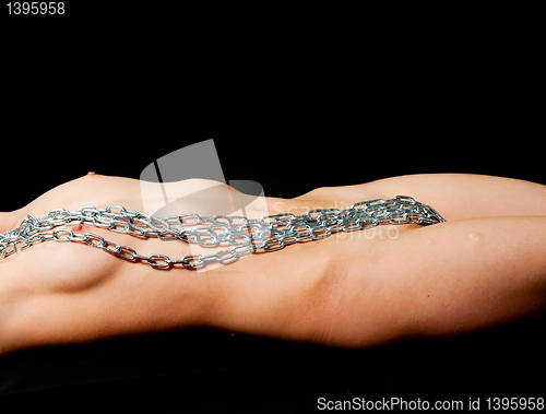 Image of Chains laying on body of pretty woman