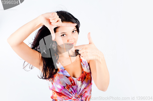 Image of Girl with frame gesture. Focus on fingers