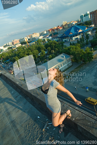 Image of Young woman on roof