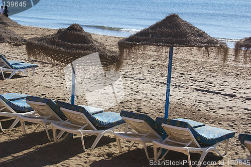 Image of sunbeds and parasols