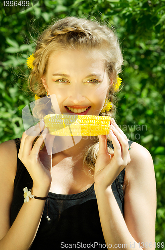 Image of woman eating corn-cob