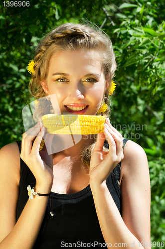 Image of woman eating corn-cob