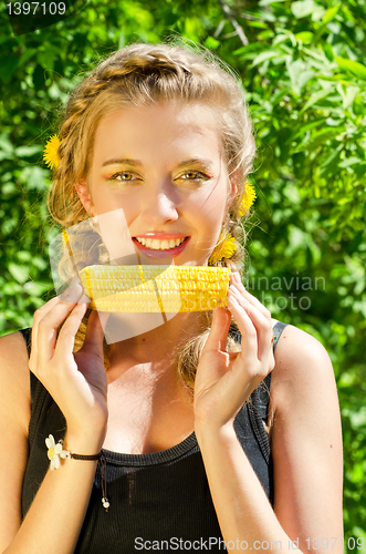 Image of woman eating corn-cob