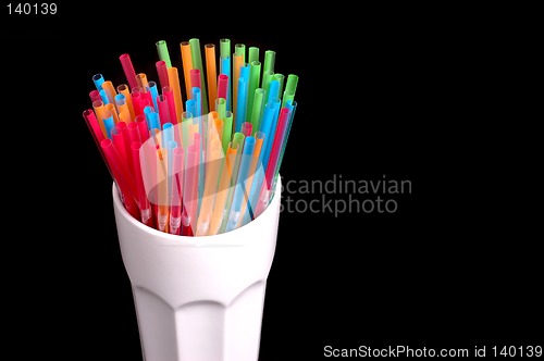 Image of Colorful straws in white glass