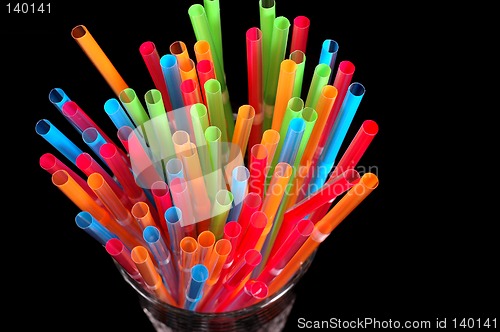 Image of Close-up of colorful straws in clear glass