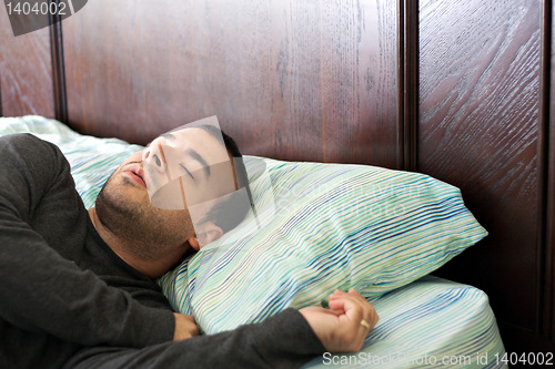 Image of Man Sleeping In Bed