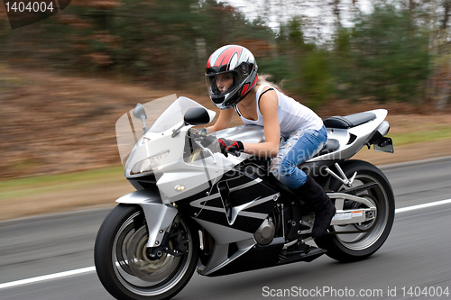 Image of Speeding Motorcycle Woman