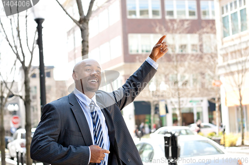 Image of Business Man Hails a Taxi