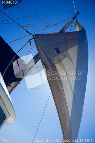 Image of Looking up at sails and mast of boat / yachting 