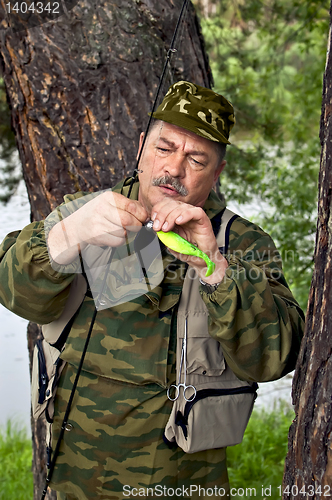 Image of Fisherman with spinning and lure