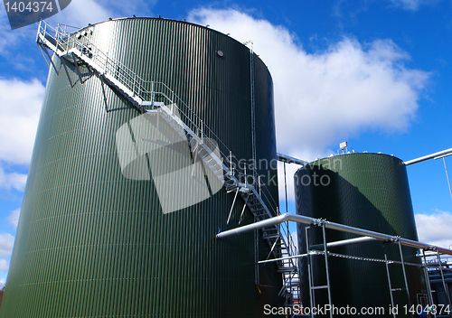 Image of Industrial zone, Steel pipelines and tanks against blue sky