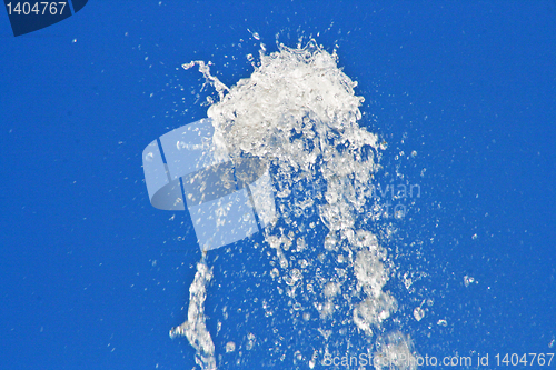 Image of  fountain of water against blue sky