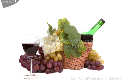 Image of white and red grape with leaves and bottle of wine