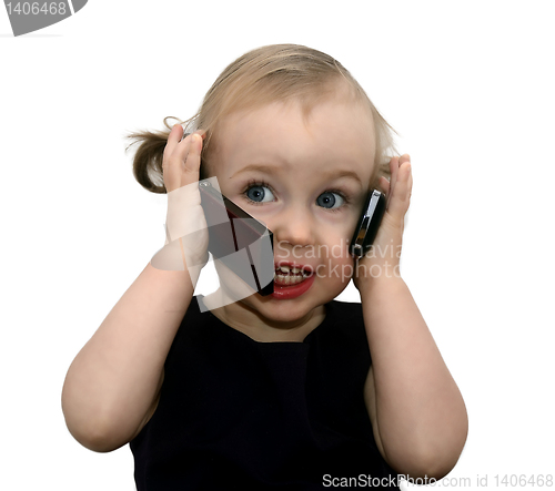 Image of funny little girl talking on the two phones, isolated on white