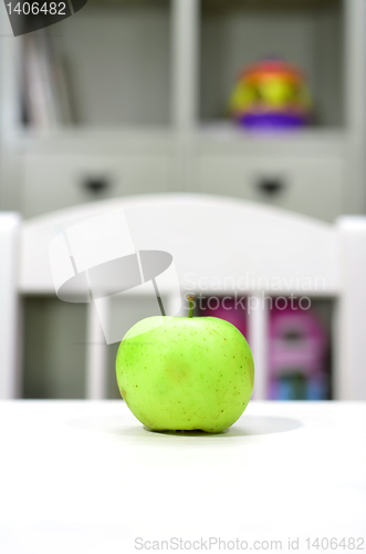 Image of green apple on the table in the nursery