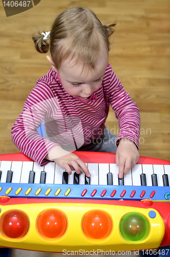 Image of little girl playing the piano