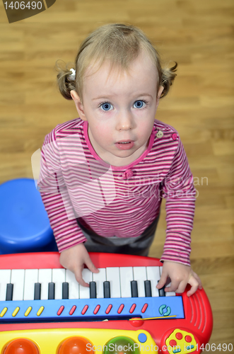 Image of little girl playing the piano