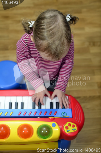 Image of little girl playing the piano