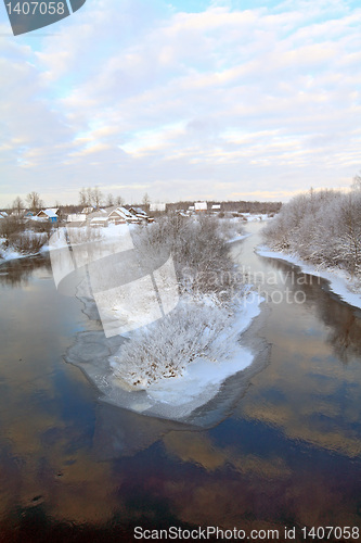 Image of snow village on coast river