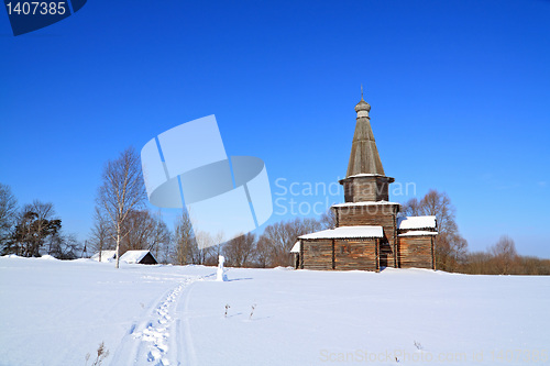 Image of wooden chapel on snow field