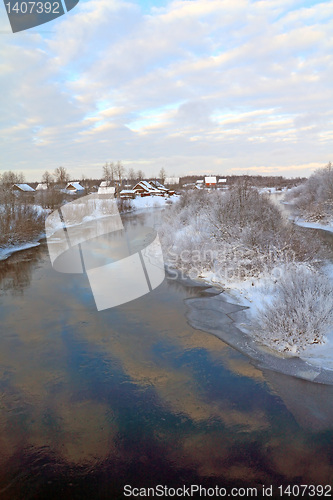 Image of snow village on coast river