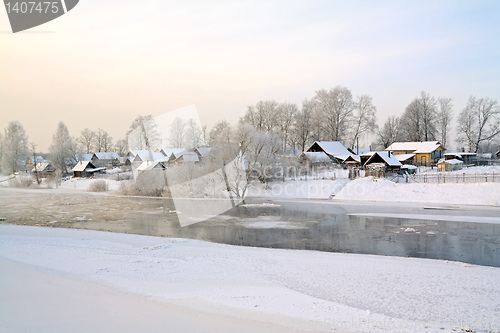 Image of winter village on coast river 