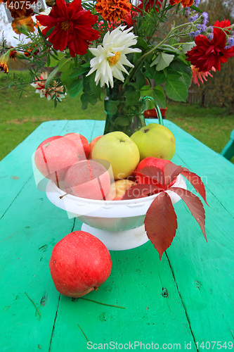 Image of autumn still life on green table in garden