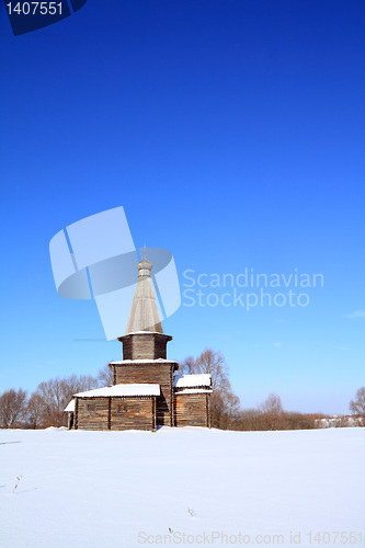 Image of wooden chapel on snow field