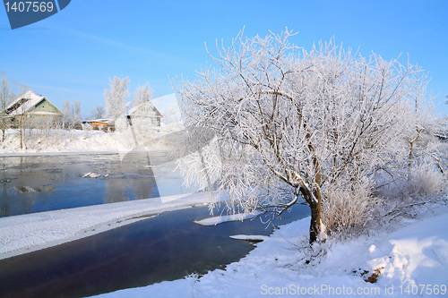 Image of winter village on coast river 