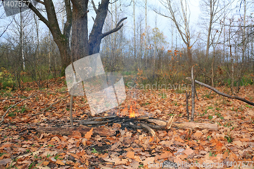 Image of small campfire amongst yellow sheet