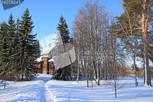 Image of wooden chapel in winter wood