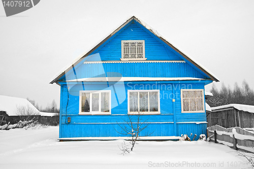 Image of blue house amongst white snow