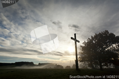 Image of dramatic sky and a cross