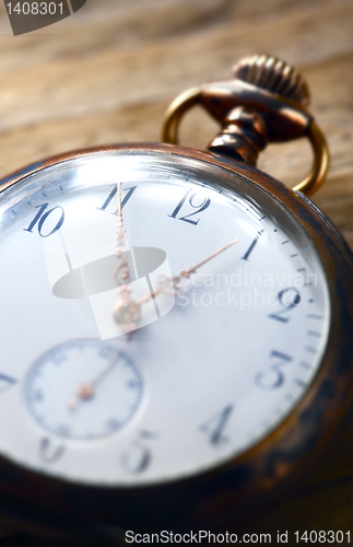 Image of vintage pocket watch on wooden background 