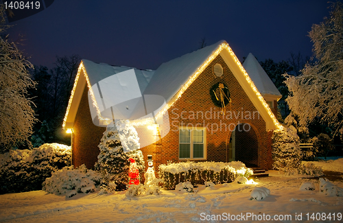 Image of Christmas decorated cottage at night