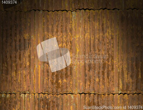 Image of Rusty corrugated metal roof panels lit dramatically