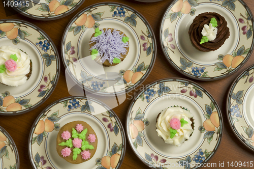 Image of Ornately decorated cupcakes on plates