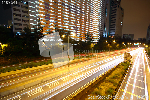 Image of urban area dusk, busy traffic 