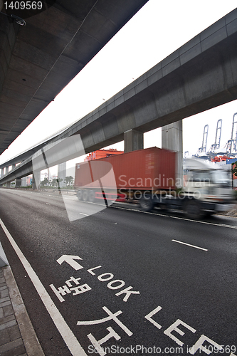 Image of speed container car moving under the overpass
