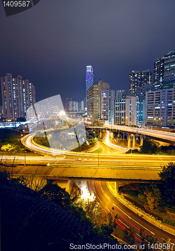 Image of urban area dusk, busy traffic 