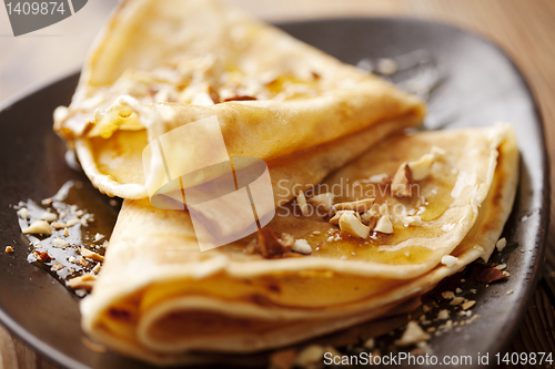 Image of crepes with honey or syrup and roasted nuts