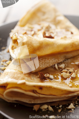 Image of crepes with honey or syrup and roasted nuts