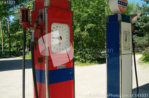 Image of Two old gasoline pumps