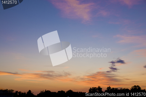 Image of Orange clouds over the horizon at sunrise