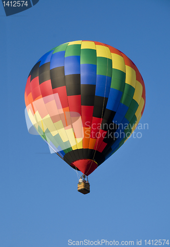 Image of Colorful hot-air balloon against blue sky